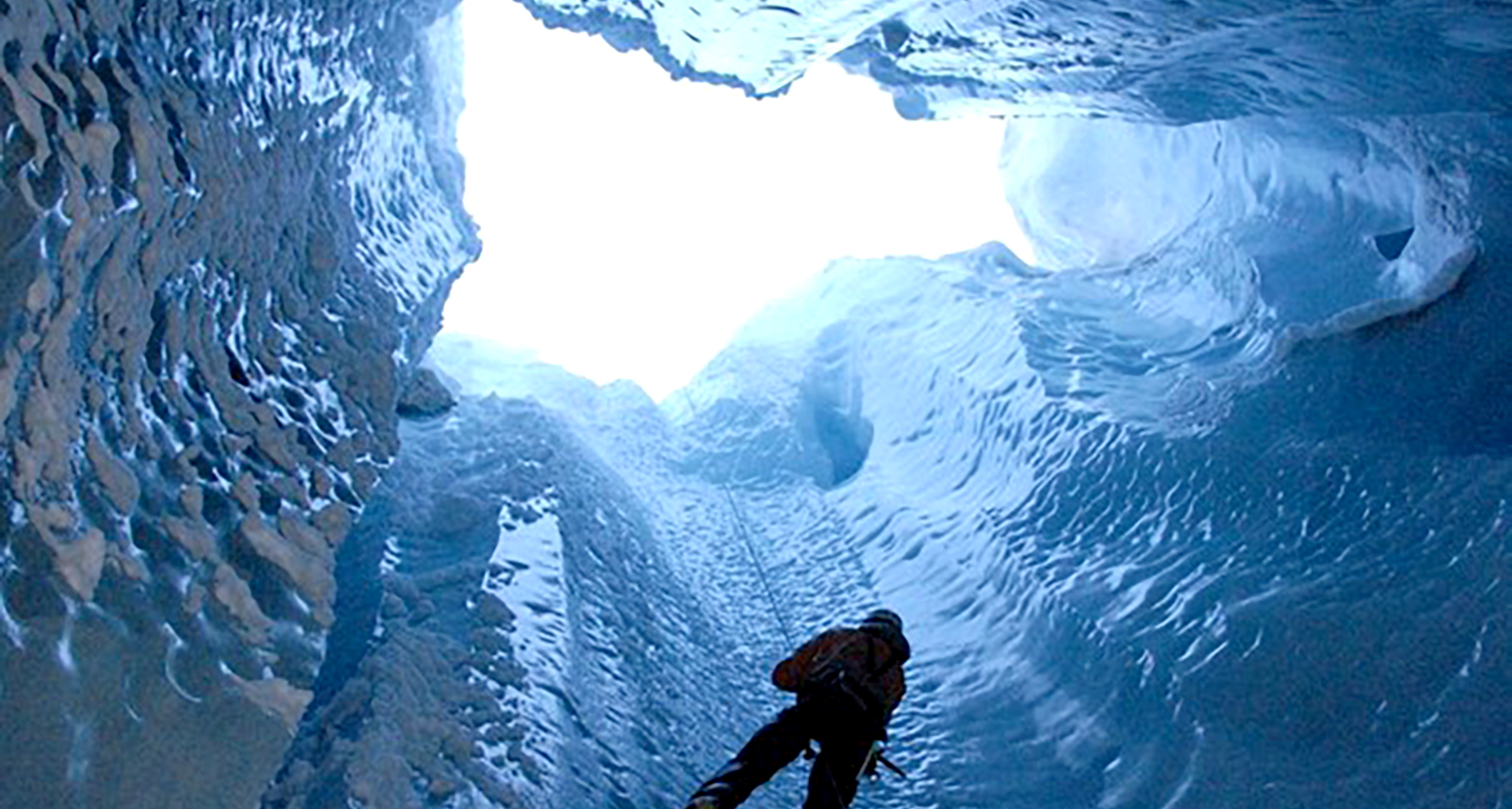 A Scientist descends into a Glacier Moulin. 